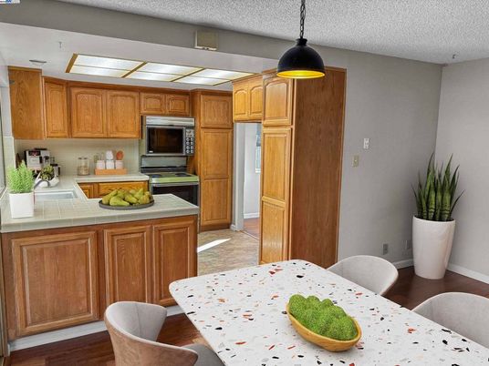 Interior, Kitchen, Pendant Lights, Stainless Steel Appliances, Tile Countertops, Wood Texture Flooring