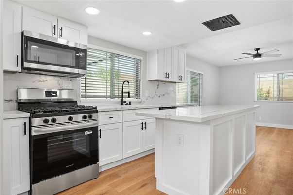 Interior, Kitchen, Marble Walls, Recessed Lighting, Stainless Steel Appliances, Wood Texture Flooring