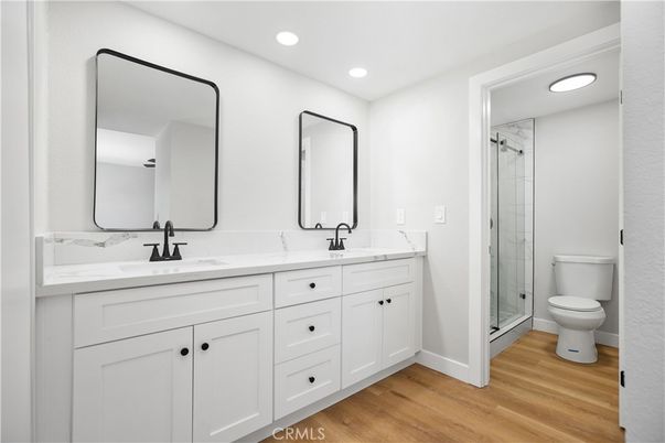 Bathroom, Dual Sink Vanities, Glass Shower, Interior, Recessed Lighting, Wood Texture Flooring