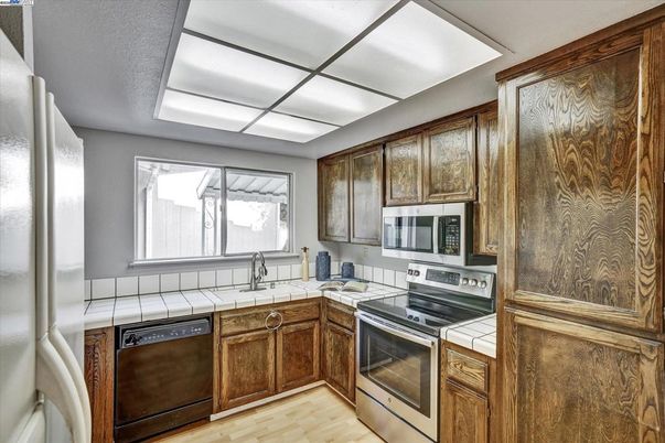 Interior, Kitchen, Stainless Steel Appliances, Tile Countertops, Wood Texture Flooring