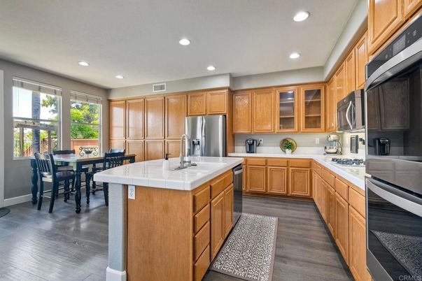 Dining room, Interior, Kitchen, Recessed Lighting, Stainless Steel Appliances, Tile Countertops, Wood Texture Flooring