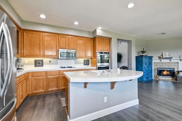 Fireplace, Interior, Kitchen, Recessed Lighting, Stainless Steel Appliances, Wood Texture Flooring