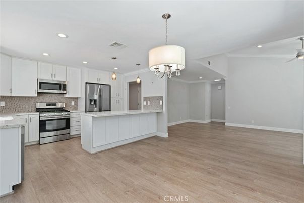 Chandelier, Interior, Kitchen, Pendant Lights, Recessed Lighting, Stainless Steel Appliances, Wood Texture Flooring