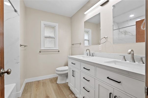 Bathroom, Dual Sink Vanities, Interior, Marble Walls, Recessed Lighting, Wood Texture Flooring