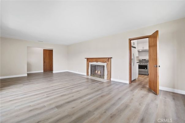 Empty room, Fireplace, Interior, Kitchen, Stainless Steel Appliances, Wood Texture Flooring