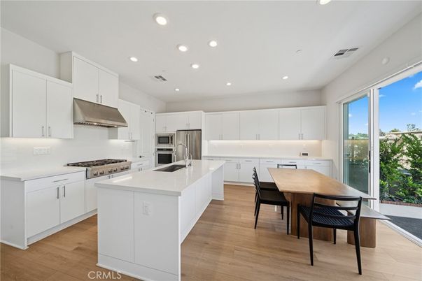 Dining room, Interior, Kitchen, Recessed Lighting, Stainless Steel Appliances, Wood Texture Flooring