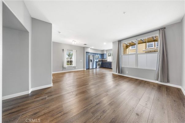 Empty room, Interior, Kitchen, Recessed Lighting, Stainless Steel Appliances, Wood Texture Flooring