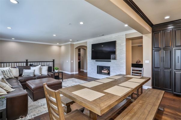 Dining room, Fireplace, Interior, Living room, Recessed Lighting, Stone Walls, Wood Texture Flooring