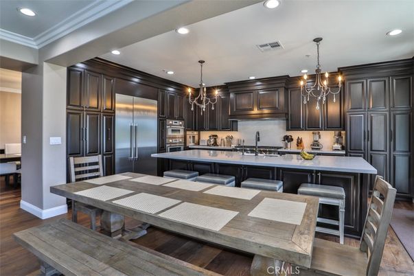Chandelier, Dining room, Interior, Kitchen, Pendant Lights, Recessed Lighting, Stainless Steel Appliances, Wood Texture Flooring