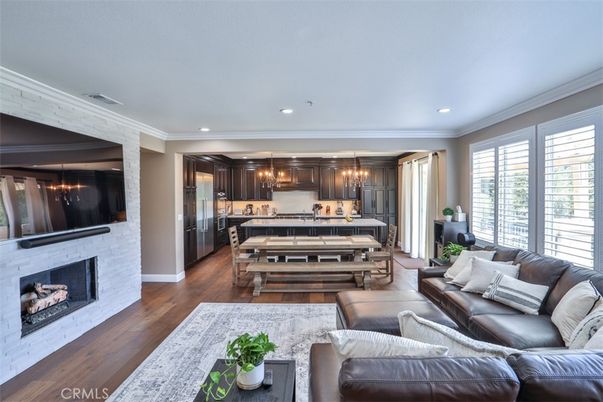 Chandelier, Dining room, Fireplace, Interior, Kitchen, Living room, Pendant Lights, Recessed Lighting, Stainless Steel Appliances, Wood Texture Flooring
