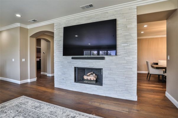 Dining room, Fireplace, Interior, Recessed Lighting, Stone Walls, Wood Texture Flooring