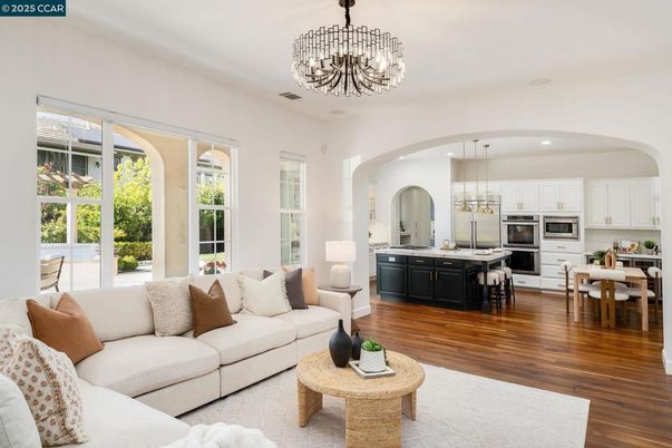 Chandelier, Dining room, Interior, Kitchen, Living room, Pendant Lights, Recessed Lighting, Stainless Steel Appliances, Wood Texture Flooring