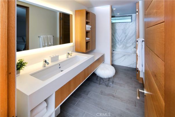 Bathroom, Dual Sink Vanities, Interior, Marble Walls, Recessed Lighting, Wood Texture Flooring