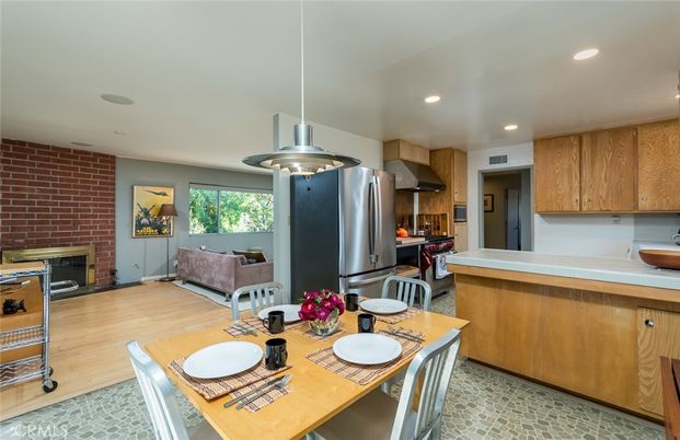 Dining room, Fireplace, Interior, Kitchen, Pendant Lights, Recessed Lighting, Stainless Steel Appliances, Stone Walls, Wood Texture Flooring