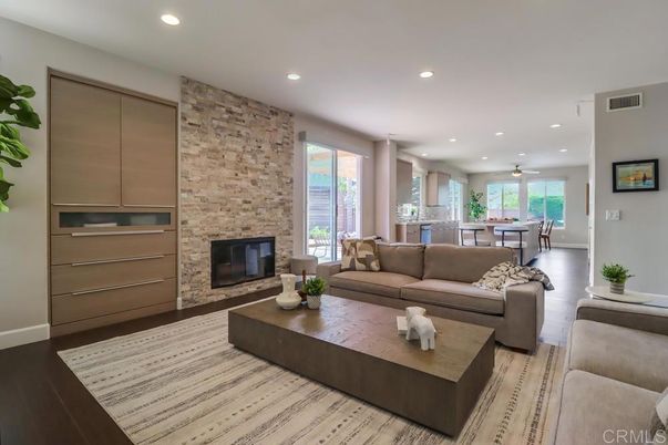 Dining room, Fireplace, Interior, Kitchen, Living room, Recessed Lighting, Stainless Steel Appliances, Stone Walls, Wood Texture Flooring