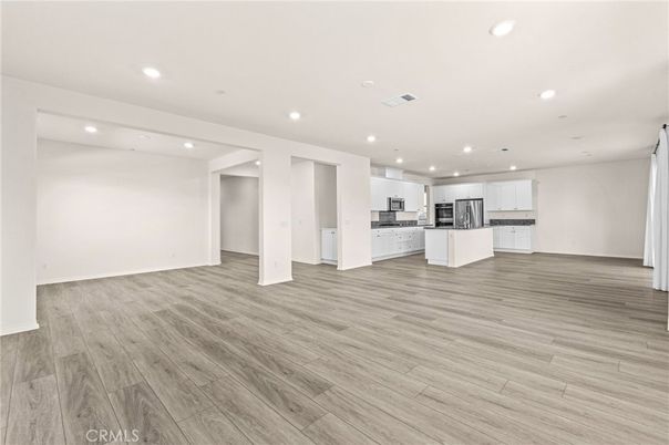 Empty room, Interior, Kitchen, Recessed Lighting, Stainless Steel Appliances, Wood Texture Flooring
