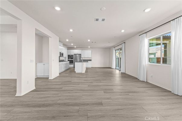 Empty room, Interior, Kitchen, Recessed Lighting, Stainless Steel Appliances, Wood Texture Flooring