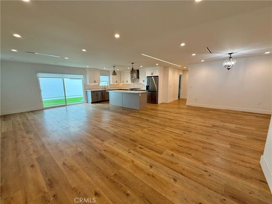 Chandelier, Empty room, Interior, Kitchen, Pendant Lights, Recessed Lighting, Stainless Steel Appliances, Wood Texture Flooring