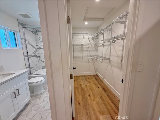 Bathroom, Glass Shower, Interior, Marble Walls, Recessed Lighting, Walk-in Closets, Wood Texture Flooring