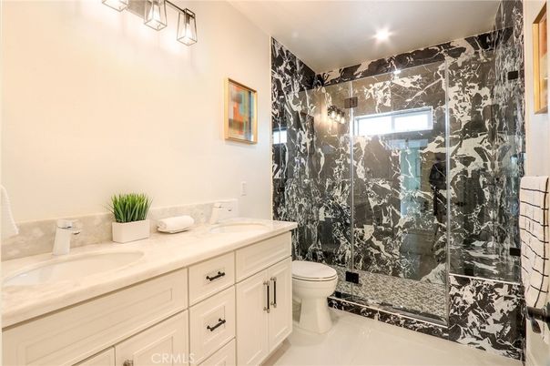 Bathroom, Dual Sink Vanities, Glass Shower, Interior, Marble Walls, Recessed Lighting