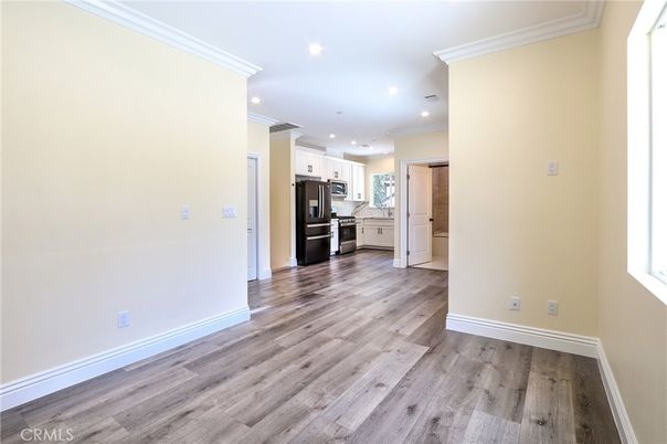 Empty room, Interior, Kitchen, Recessed Lighting, Stainless Steel Appliances, Wood Texture Flooring
