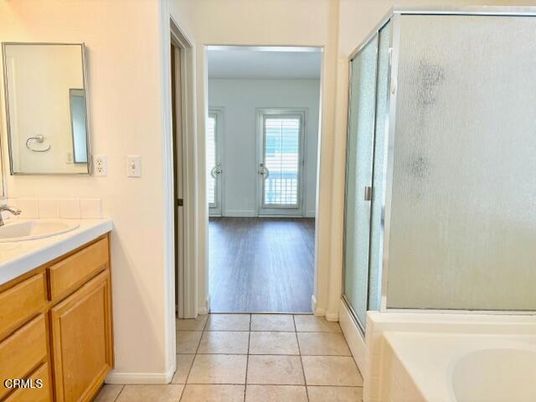 Bathroom, Dual Sink Vanities, Glass Shower, Interior, Tile Countertops, Wood Texture Flooring