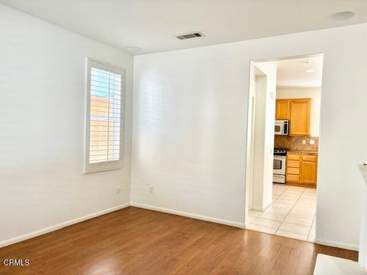Empty room, Interior, Kitchen, Recessed Lighting, Stainless Steel Appliances, Wood Texture Flooring