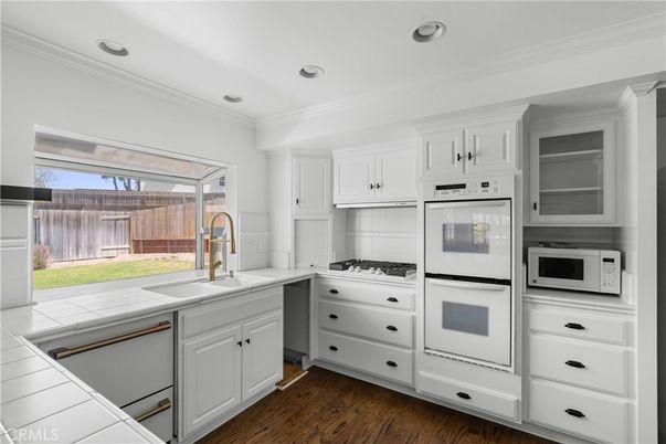 Interior, Kitchen, Recessed Lighting, Tile Countertops, Wood Texture Flooring