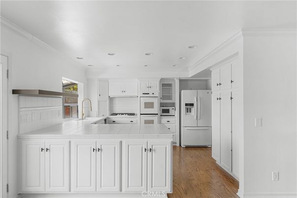Interior, Kitchen, Recessed Lighting, Tile Countertops, Wood Texture Flooring