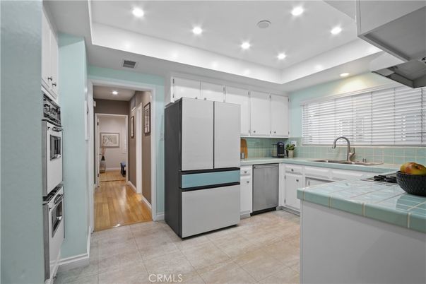 Interior, Kitchen, Recessed Lighting, Stainless Steel Appliances, Tile Countertops, Wood Texture Flooring