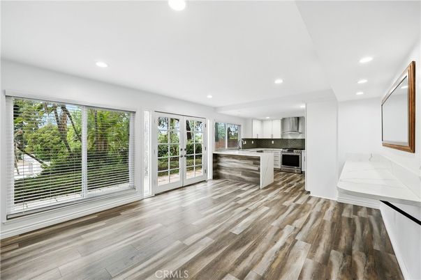 Empty room, Interior, Kitchen, Recessed Lighting, Stainless Steel Appliances, Wood Texture Flooring