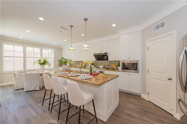 Dining room, Interior, Kitchen, Pendant Lights, Recessed Lighting, Stainless Steel Appliances, Wood Texture Flooring