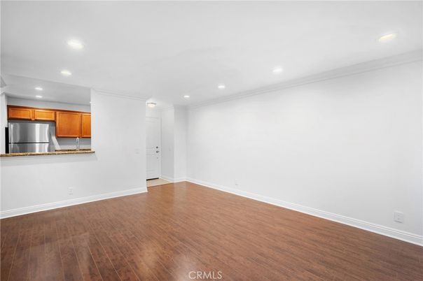 Empty room, Interior, Kitchen, Recessed Lighting, Stainless Steel Appliances, Wood Texture Flooring