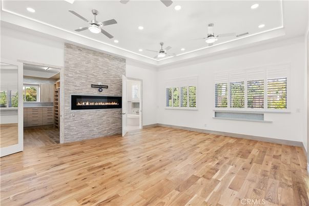 Empty room, Fireplace, Interior, Recessed Lighting, Stone Walls, Wood Texture Flooring