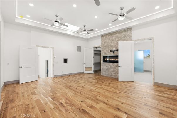 Empty room, Fireplace, Interior, Recessed Lighting, Stone Walls, Wood Texture Flooring