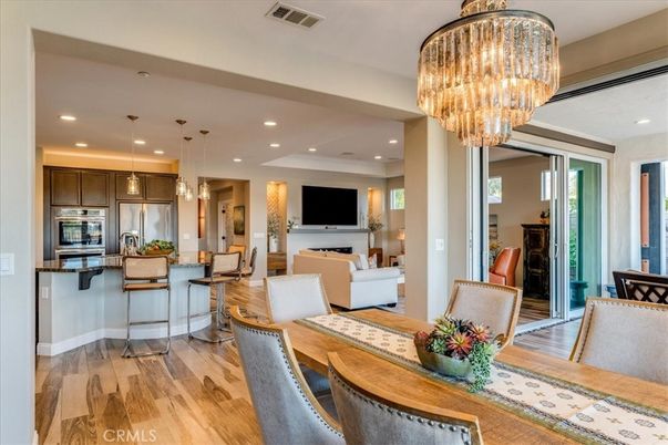 Chandelier, Dining room, Interior, Kitchen, Living room, Pendant Lights, Recessed Lighting, Stainless Steel Appliances, Wood Texture Flooring