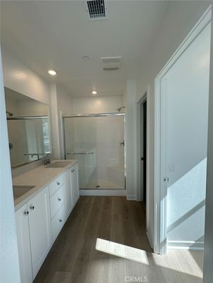 Bathroom, Dual Sink Vanities, Glass Shower, Interior, Recessed Lighting, Wood Texture Flooring