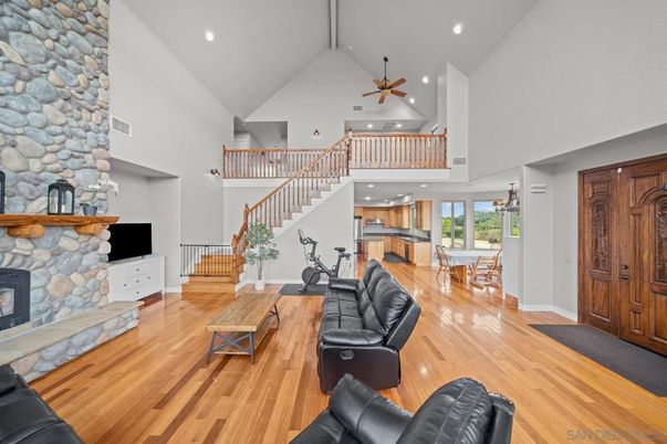 Dining room, Fireplace, Fitness Equipment, Interior, Living room, Recessed Lighting, Stone Walls, Wood Texture Flooring