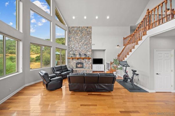 Fireplace, Fitness Equipment, Interior, Living room, Recessed Lighting, Stone Walls, Wood Texture Flooring