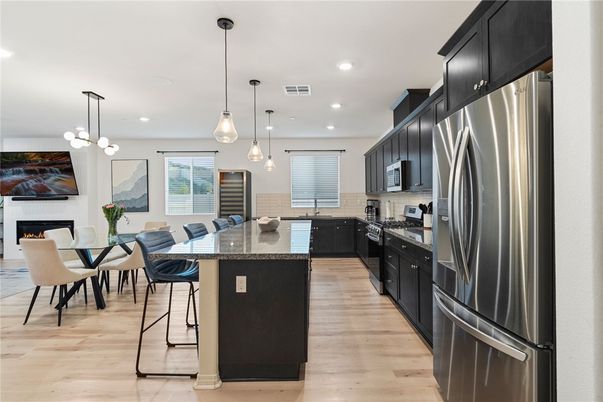 Dining room, Fireplace, Interior, Kitchen, Pendant Lights, Recessed Lighting, Stainless Steel Appliances, Wood Texture Flooring