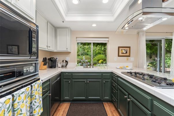 Interior, Kitchen, Recessed Lighting, Stainless Steel Appliances, Tile Countertops, Wood Texture Flooring