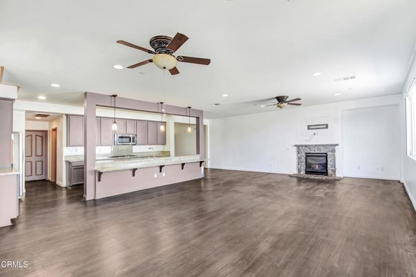 Empty room, Fireplace, Interior, Kitchen, Pendant Lights, Recessed Lighting, Wood Texture Flooring