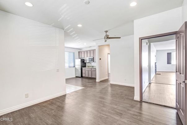 Empty room, Interior, Kitchen, Recessed Lighting, Stainless Steel Appliances, Wood Texture Flooring
