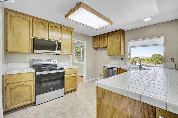 Interior, Kitchen, Recessed Lighting, Stainless Steel Appliances, Tile Countertops