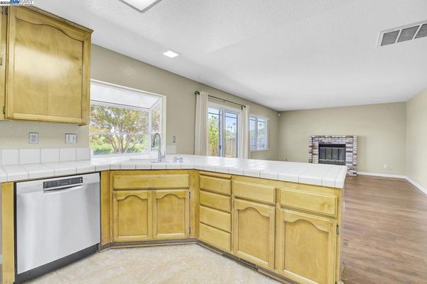 Fireplace, Interior, Kitchen, Recessed Lighting, Tile Countertops, Wood Texture Flooring