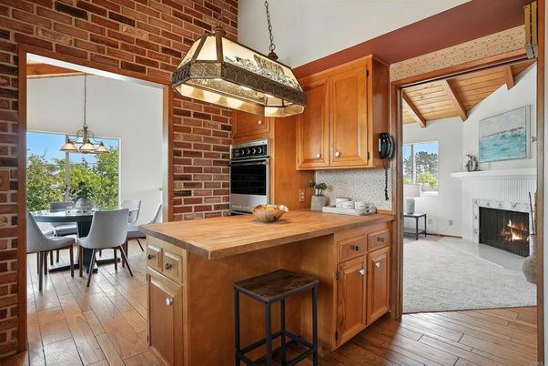 Dining room, Fireplace, Interior, Kitchen, Pendant Lights, Stainless Steel Appliances, Stone Walls, Wooden Ceilings, Wood Texture Flooring