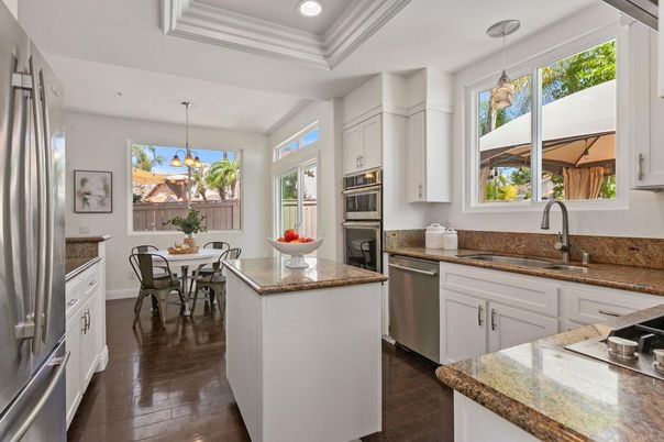 Chandelier, Dining room, Interior, Kitchen, Pendant Lights, Recessed Lighting, Stainless Steel Appliances, Wood Texture Flooring