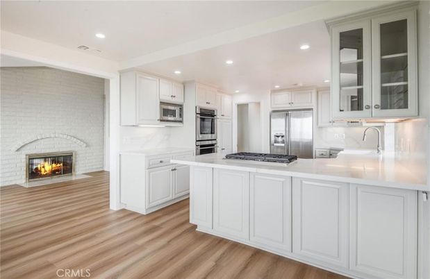 Fireplace, Interior, Kitchen, Recessed Lighting, Stainless Steel Appliances, Wood Texture Flooring