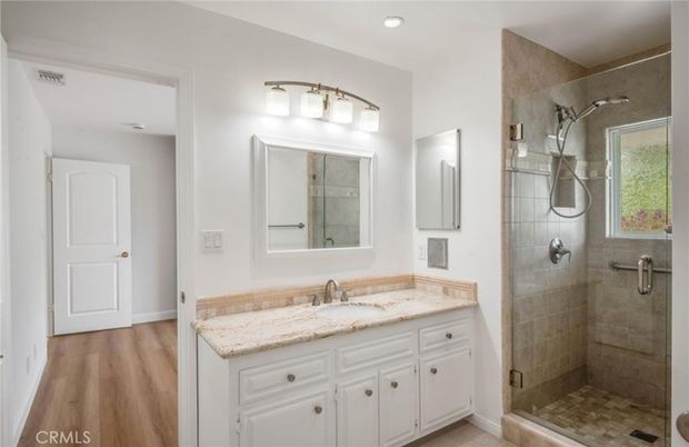 Bathroom, Dual Sink Vanities, Glass Shower, Interior, Recessed Lighting, Wood Texture Flooring