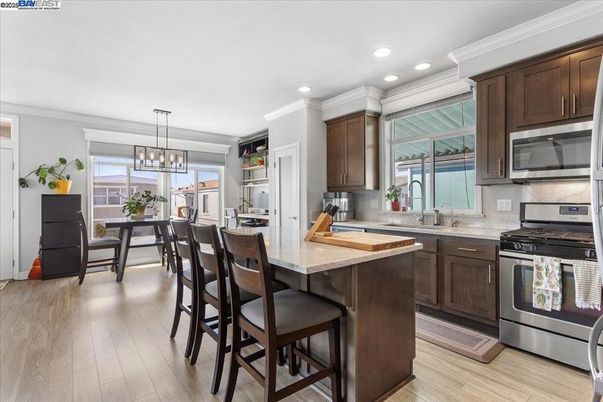 Chandelier, Dining room, Interior, Kitchen, Pendant Lights, Recessed Lighting, Stainless Steel Appliances, Wood Texture Flooring